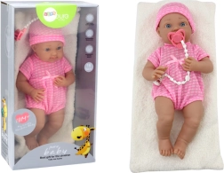 Poupée bébé en tenue rose avec bonnet, tétine et couverture
