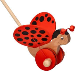 Coccinelle pousse-pousse en bois sur tige