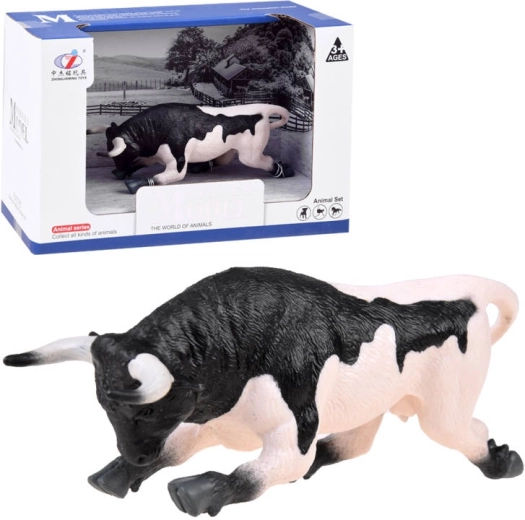 Figurine animale d'un taureau noir et blanc prêt à attaquer