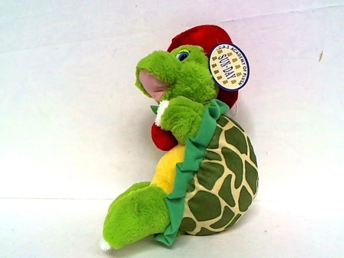 Tortue en peluche avec chapeau rouge et pomme