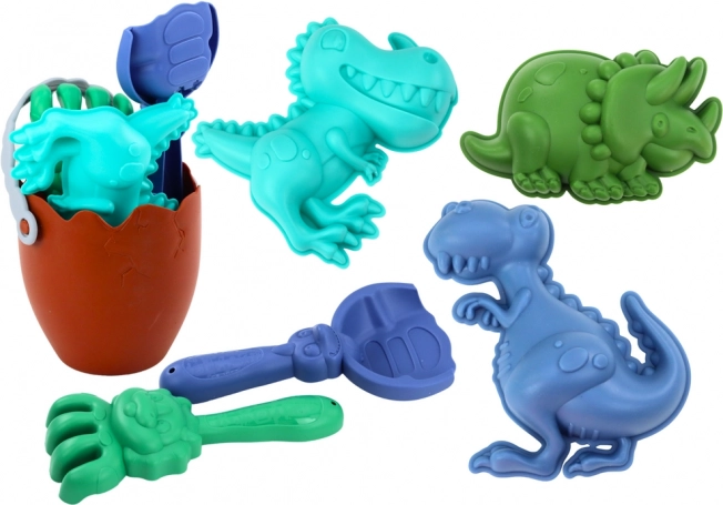 Set de sable dinosaures avec seau en forme d’œuf, pelle, râteau et moules