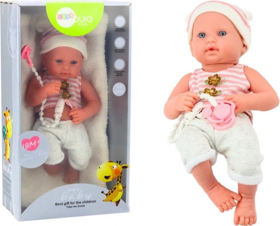 Poupée bébé en tenue blanc‑rose avec tétine et bonnet