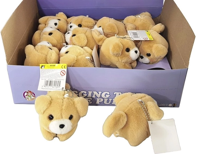 Petit chien en peluche avec mécanisme à remonter qui remue la queue