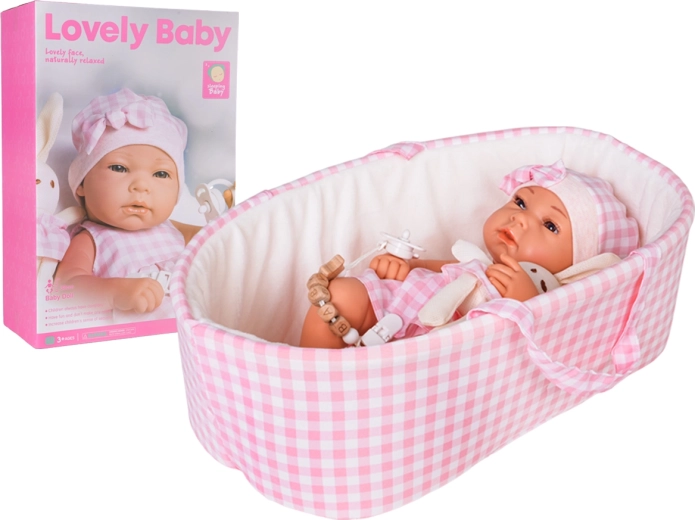 Poupée bébé dans un porte-bébé rose