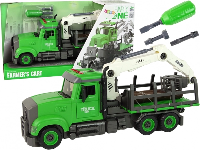 Camion vert de transport de bois avec grue et lumières