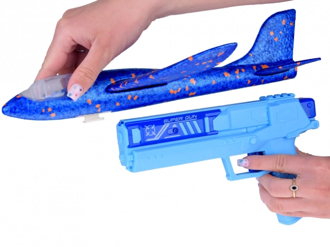Avion en mousse amusant avec lumières LED lancé depuis un pistolet