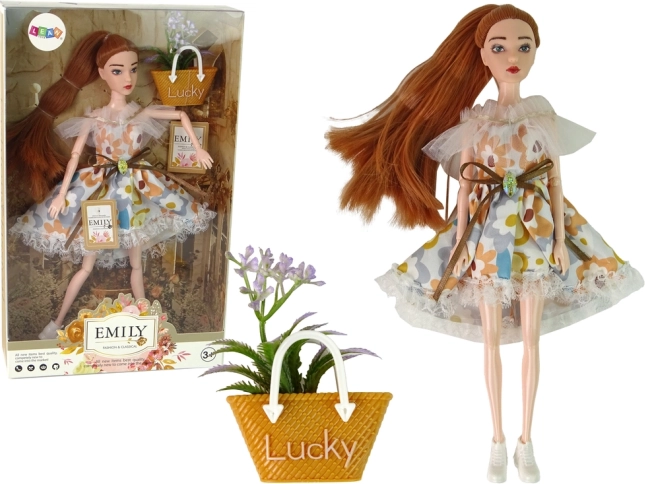 poupée Emily en robe fleurie avec accessoire d’automne