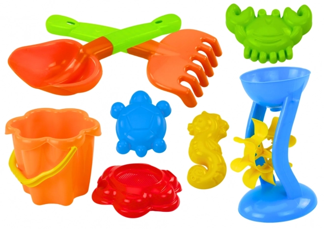 Ensemble coloré de jouets de sable avec moulin et moules