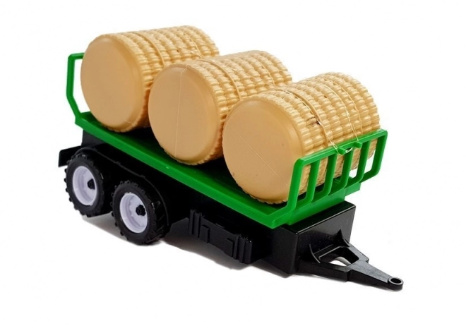 Tracteur avec remorque pour bottes de foin Citerne