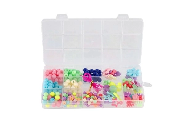 Perles en plastique colorées avec cordelette dans une boîte en plastique 10x17x2cm