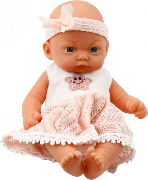 Poupée bébé en robe rose avec bandeau