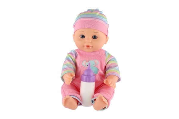 Poupée bébé 30cm en plastique dans un porte-bébé/siege auto avec biberon en blister