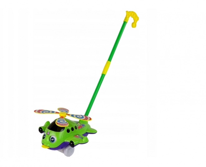 Avion pousseur vert avec longue canne et clochette