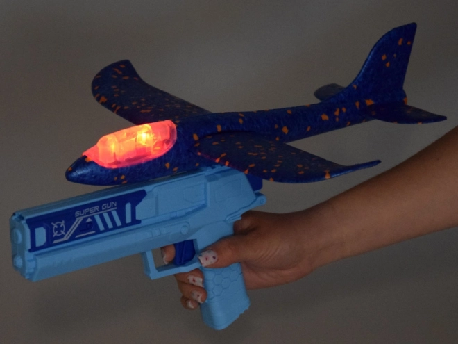 Avion en mousse amusant avec lumières LED lancé depuis un pistolet