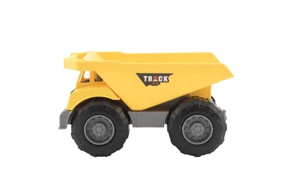 Engin de construction en plastique 18-20cm mix des types en roue libre dans un filet