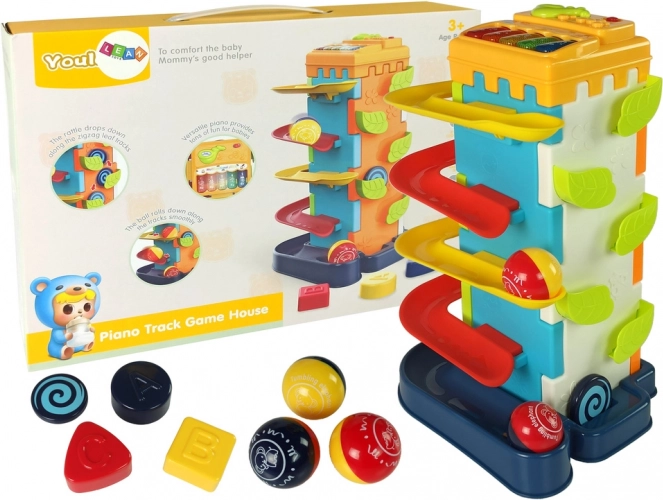 Cube éducatif avec toboggan à balles et petit piano
