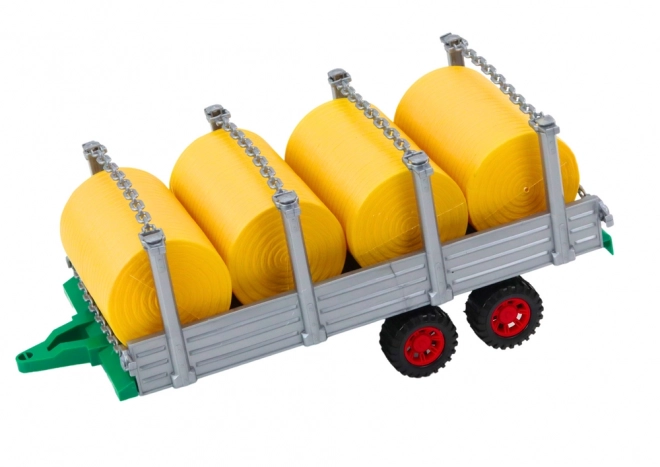 Grand tracteur avec remorque et balles de foin