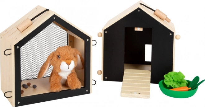 Petit pied Lapin en peluche dans un clapier avec enclos