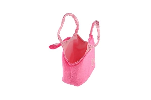 Caniche en peluche rose dans un sac à main