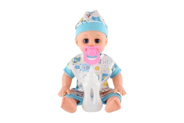 Poupée bébé plastique 32cm corps solide buvant, faisant pipi à piles avec son et accessoires dans un sac