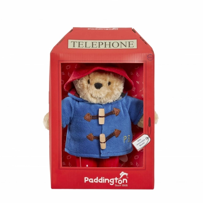Ours en peluche Paddington arc-en-ciel dans une cabine téléphonique