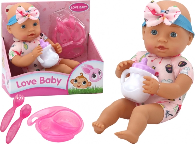 Poupée en tissu bébé avec tenue rose à flamants roses et accessoires de repas