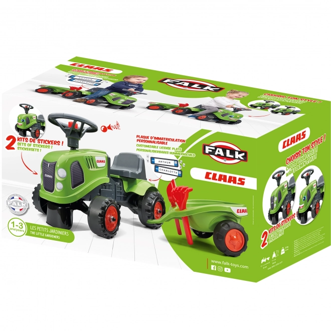 Tracteur pousseur Claas vert avec volant et remorque