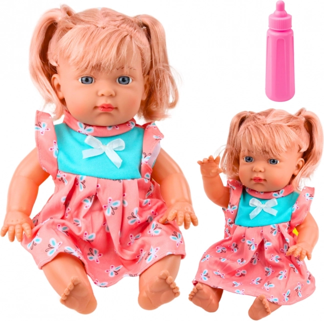 Poupée bébé en robe colorée avec biberon et sons
