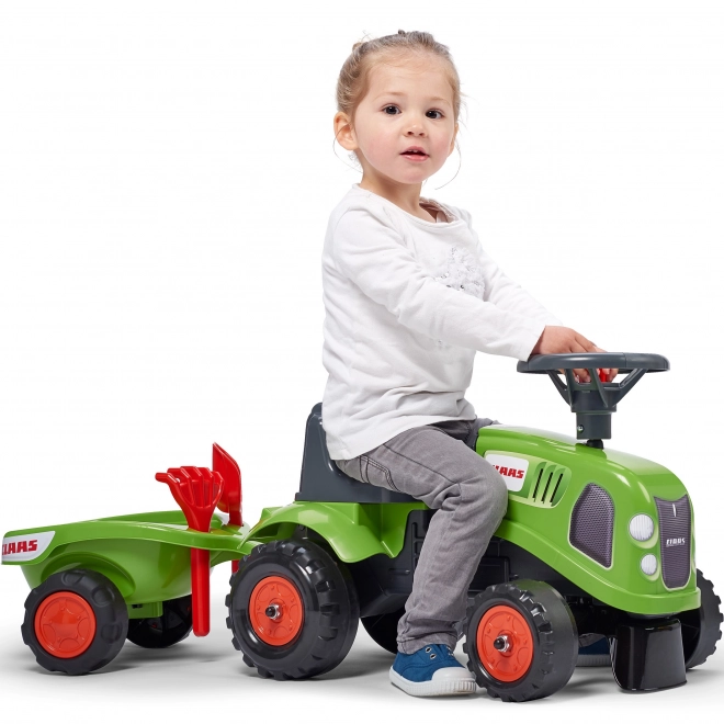 Tracteur pousseur Claas vert avec volant et remorque