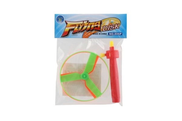 Toupie à élastique + lanceur plastique 9cm 2 couleurs en sachet
