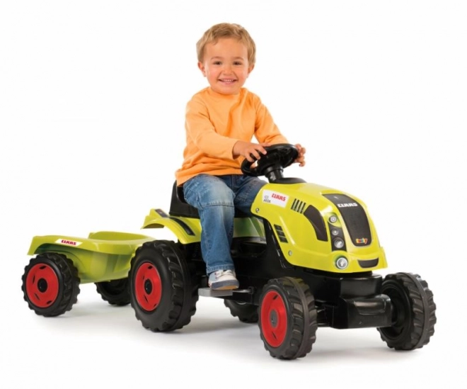 Tracteur à pédales CLAAS Arion 400 avec remorque verte