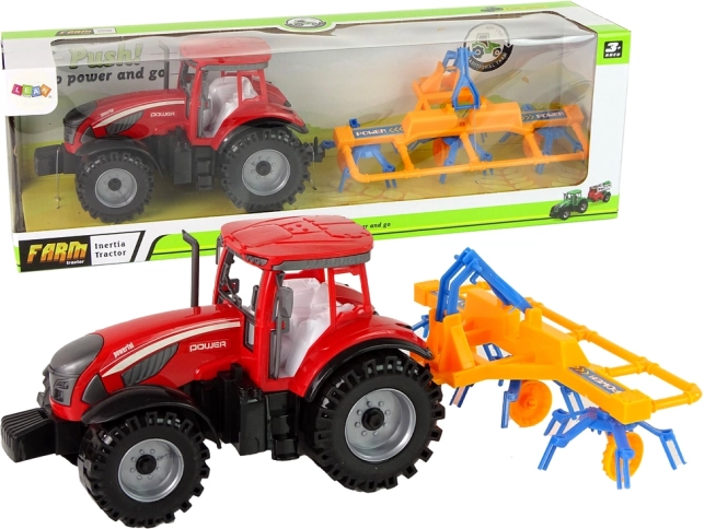 Tracteur rouge avec andaineur à friction