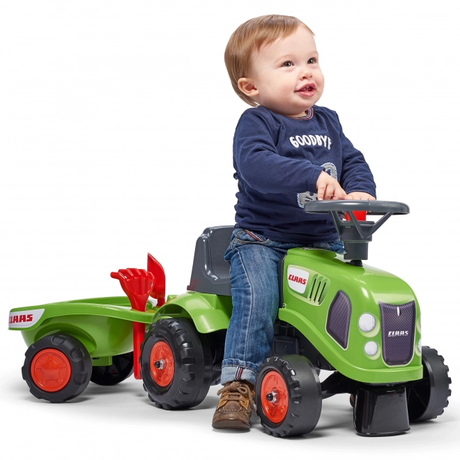 Tracteur pousseur Claas vert avec volant et remorque