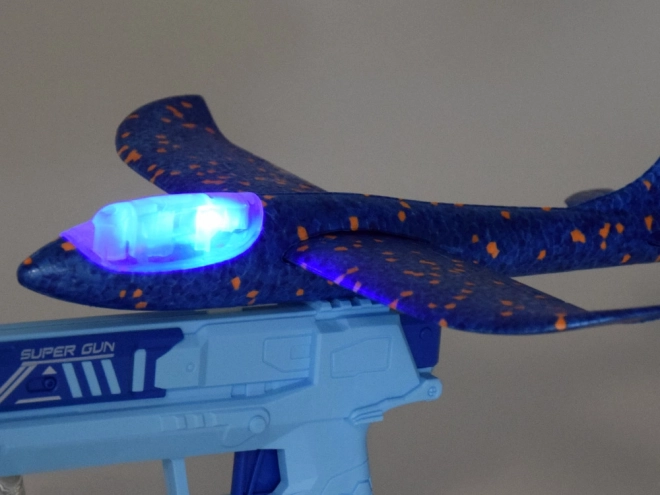 Avion en mousse amusant avec lumières LED lancé depuis un pistolet