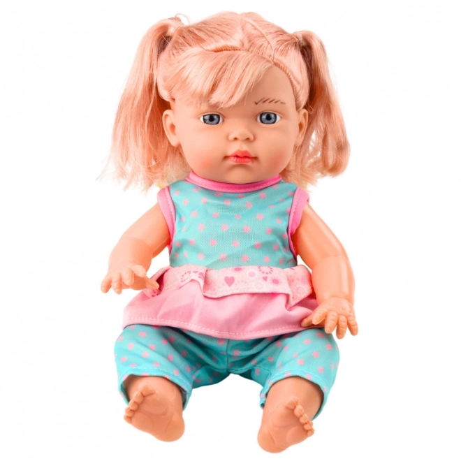 Poupée bébé en ensemble turquoise avec biberon et son