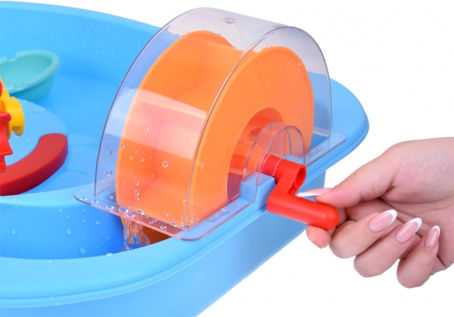 Table bleue d'eau avec roue à aubes et accessoires de pêche