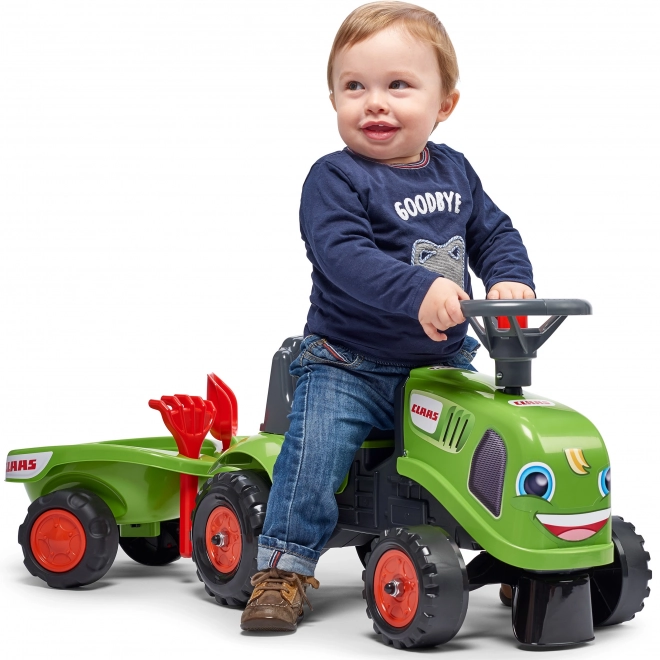 Tracteur pousseur Claas vert avec volant et remorque