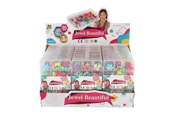 Perles en plastique colorées avec cordelette dans une boîte en plastique 10x17x2cm