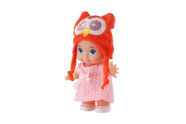 Poupée/bébé avec bonnet, plastique corps rigide 15cm, 4 types dans boîte 9x16x6cm