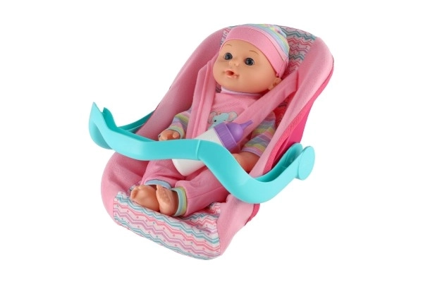 Poupée bébé 30cm en plastique dans un porte-bébé/siege auto avec biberon en blister