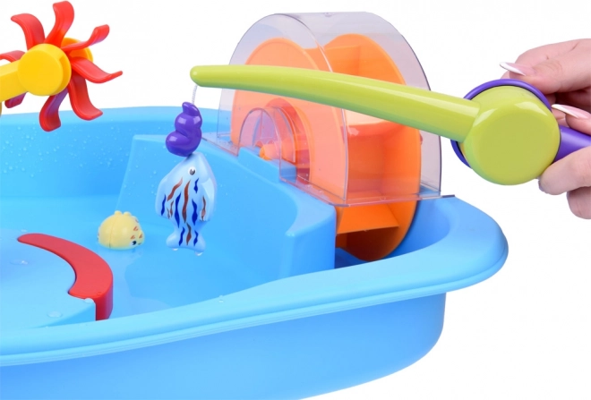 Table bleue d'eau avec roue à aubes et accessoires de pêche