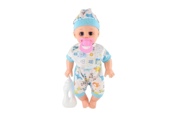 Poupée bébé plastique 32cm corps solide buvant, faisant pipi à piles avec son et accessoires dans un sac