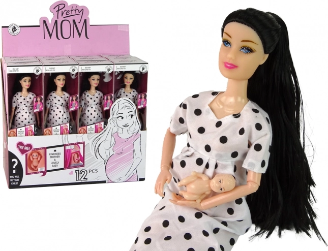 Poupée enceinte en robe blanche à pois