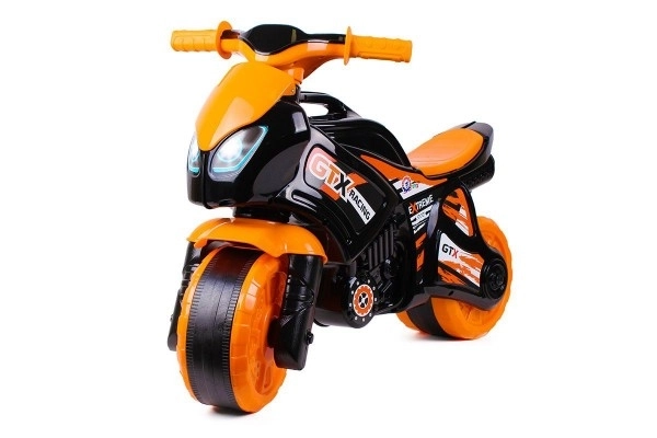 Moto trotteur orange-noir en plastique dans un sac 35x53x74cm 24m+