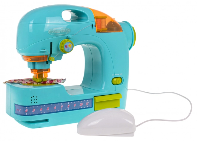 Machine à coudre bleue + accessoires