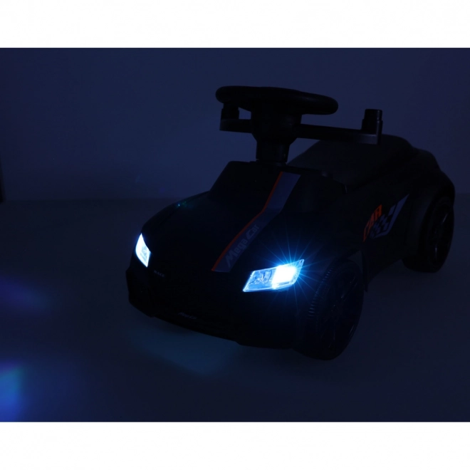 Voiture noire à pousser avec musique et lumières