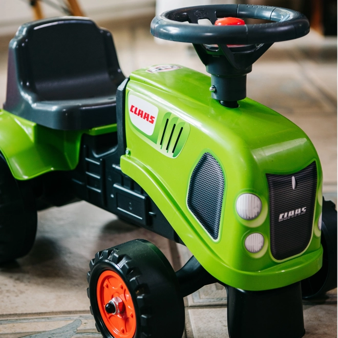 Tracteur pousseur Claas vert avec volant et remorque