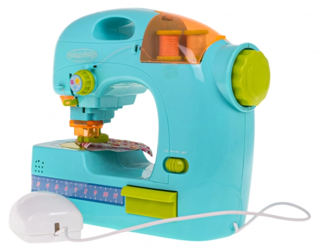 Machine à coudre bleue + accessoires