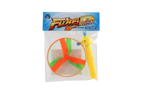 Toupie à élastique + lanceur plastique 9cm 2 couleurs en sachet