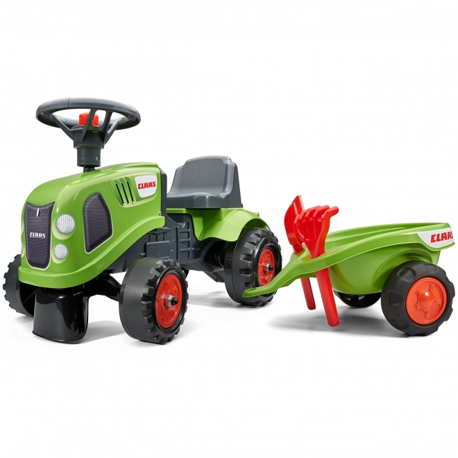 Tracteur pousseur Claas vert avec volant et remorque